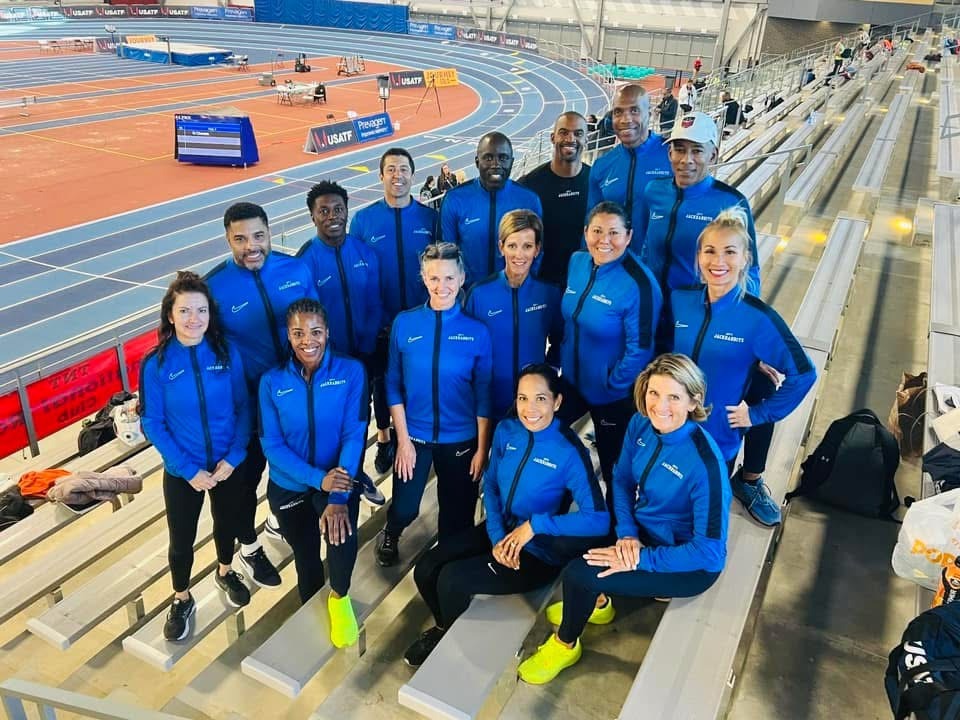 Joy's Jackrabbits masters track team in blue warm-ups at a USATF meet